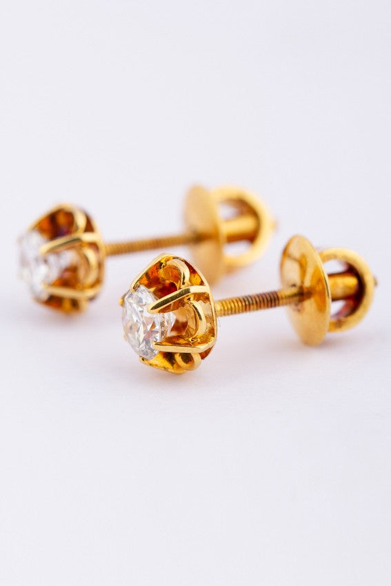 20 carat gold solitaire earrings, each with a brilliant