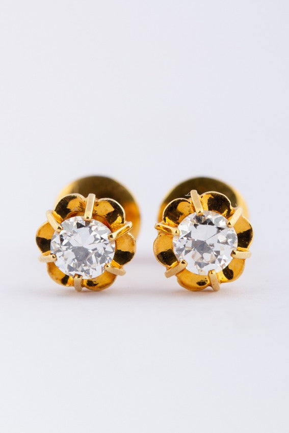 20 carat gold solitaire earrings, each with a brilliant