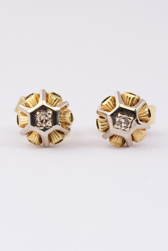 Gold stud earrings with a diamond in each one