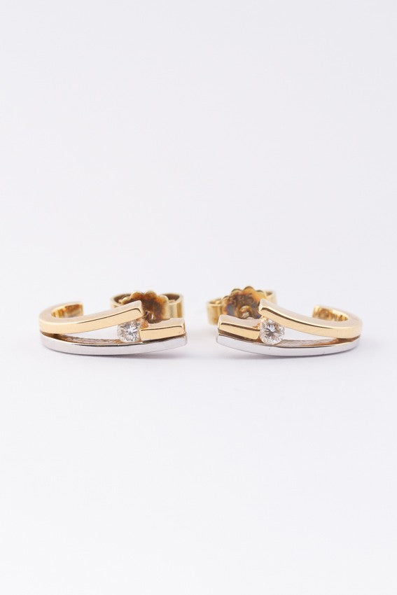 White/yellow gold stud earrings with brilliant cut diamonds