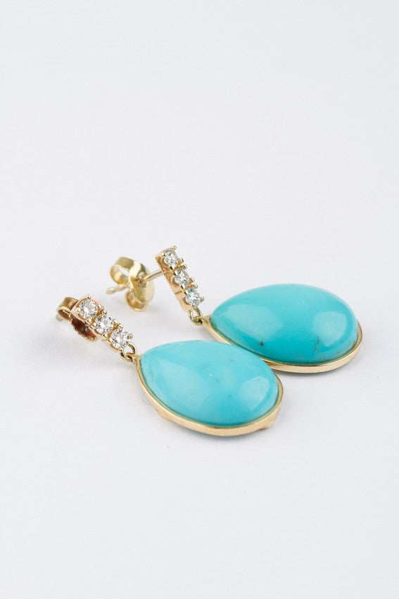 Gold earrings with a turquoise and 3 diamonds each