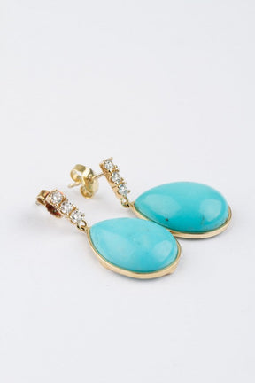 Gold earrings with a turquoise and 3 diamonds each