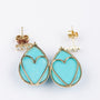 Gold earrings with a turquoise and 3 diamonds each