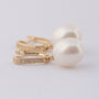 Gold earrings with a pearl and diamonds