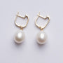 Gold earrings with a pearl and diamonds