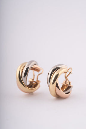Gold trinity stud earrings from Cartier