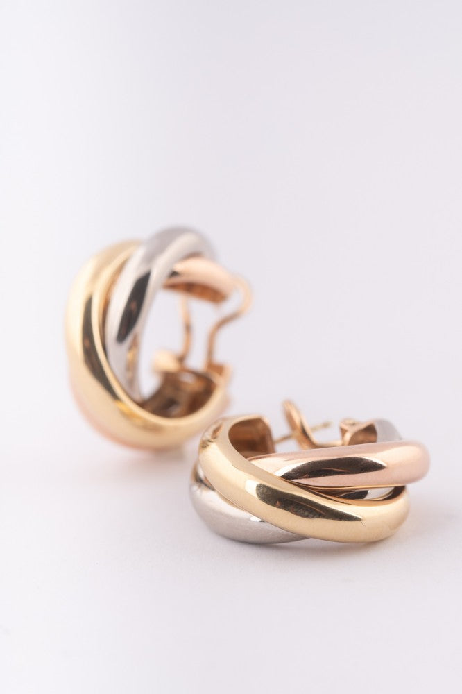Gold trinity stud earrings from Cartier