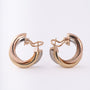 Gold trinity stud earrings from Cartier