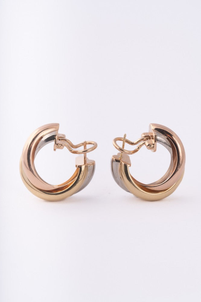 Gold trinity stud earrings from Cartier