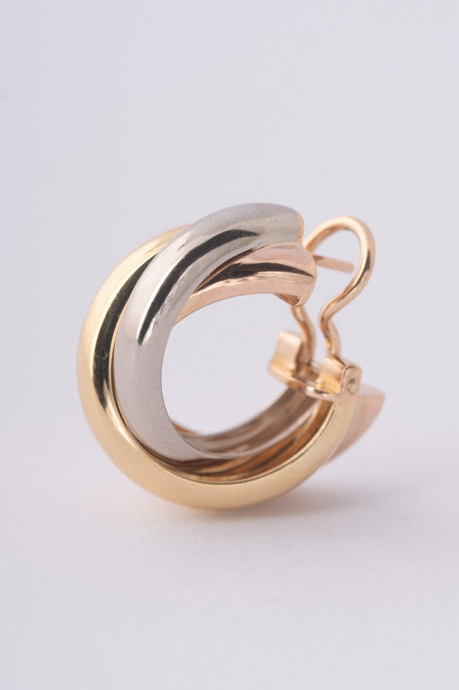 Gold trinity stud earrings from Cartier