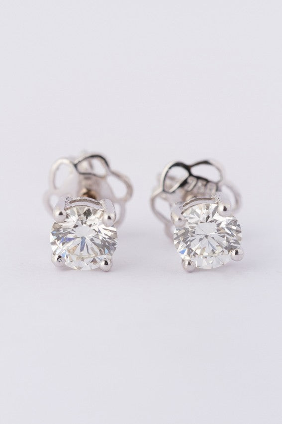 White gold solitaire earrings, each with a brilliant cut diamond. Total weight approx. 0.80 ct.