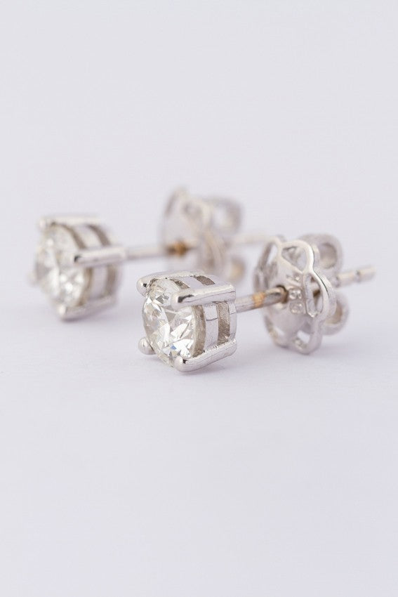 White gold solitaire earrings, each with a brilliant cut diamond. Total weight approx. 0.80 ct.
