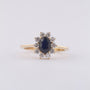 Yellow gold entourage ring with sapphire and brilliant-cut diamonds