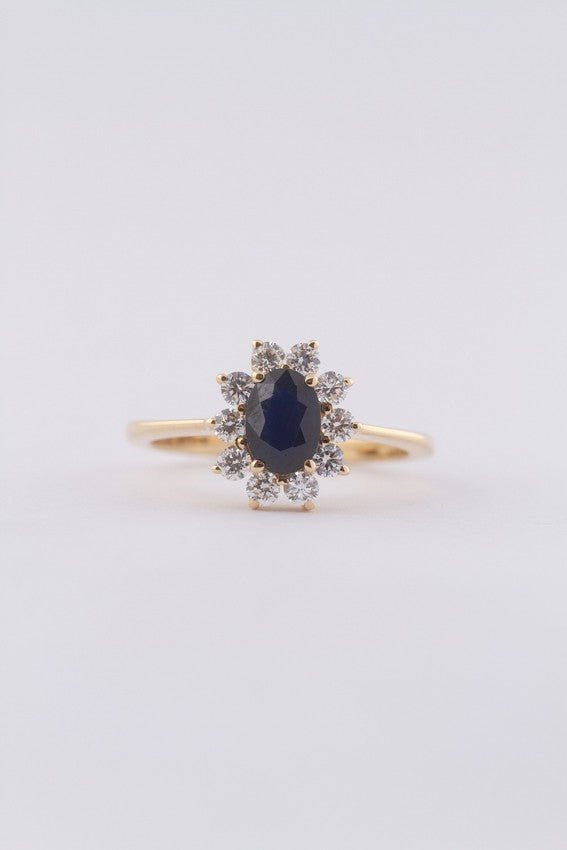 Yellow gold entourage ring with sapphire and brilliant-cut diamonds