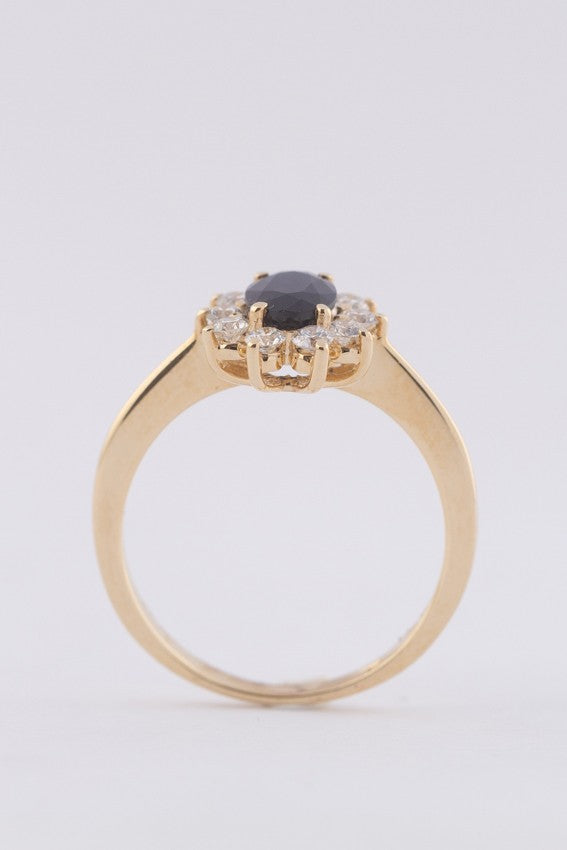 Yellow gold entourage ring with sapphire and brilliant-cut diamonds