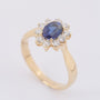 Gold entourage ring with sapphire and diamonds