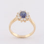 Gold entourage ring with sapphire and diamonds
