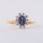 Gold entourage ring with sapphire and diamonds