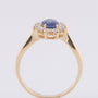 Gold entourage ring with sapphire and diamonds