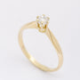 Gold solitaire ring with a brilliant