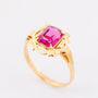 Gold ring with red crystal