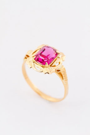 Gold ring with red crystal