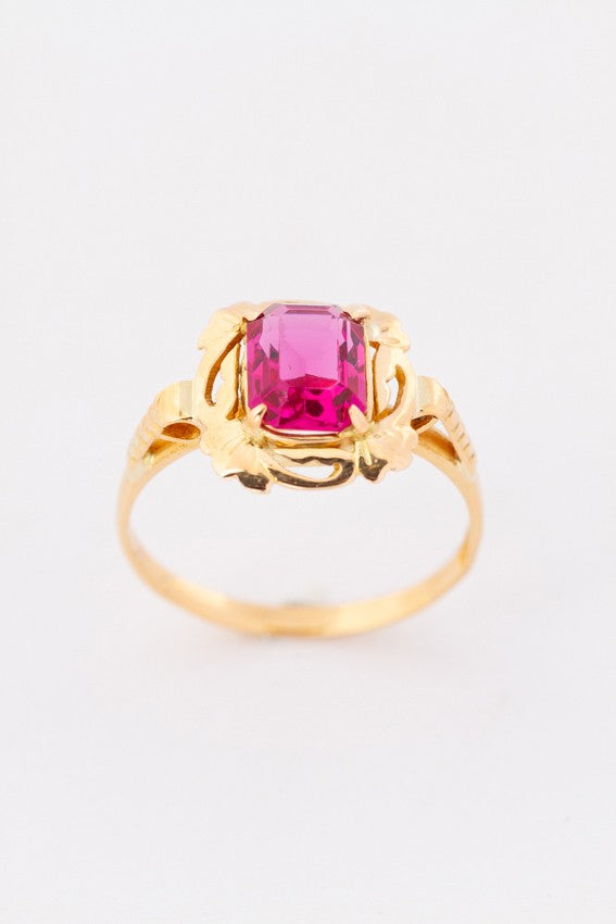 Gold ring with red crystal