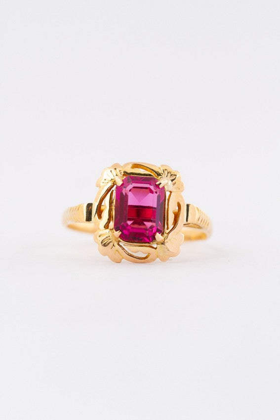 Gold ring with red crystal