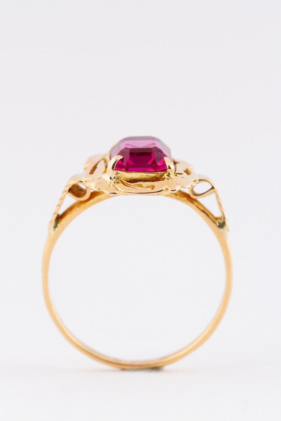 Gold ring with red crystal