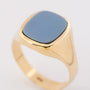 Gold ring with blue layered stone
