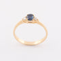 Gold row ring with sapphire and 2 brilliants