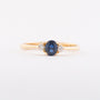 Gold row ring with sapphire and 2 brilliants