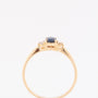Gold row ring with sapphire and 2 brilliants