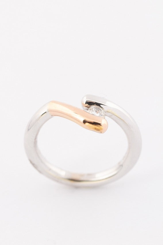 Solid white/rose gold ring with a 0.17 ct brilliant.