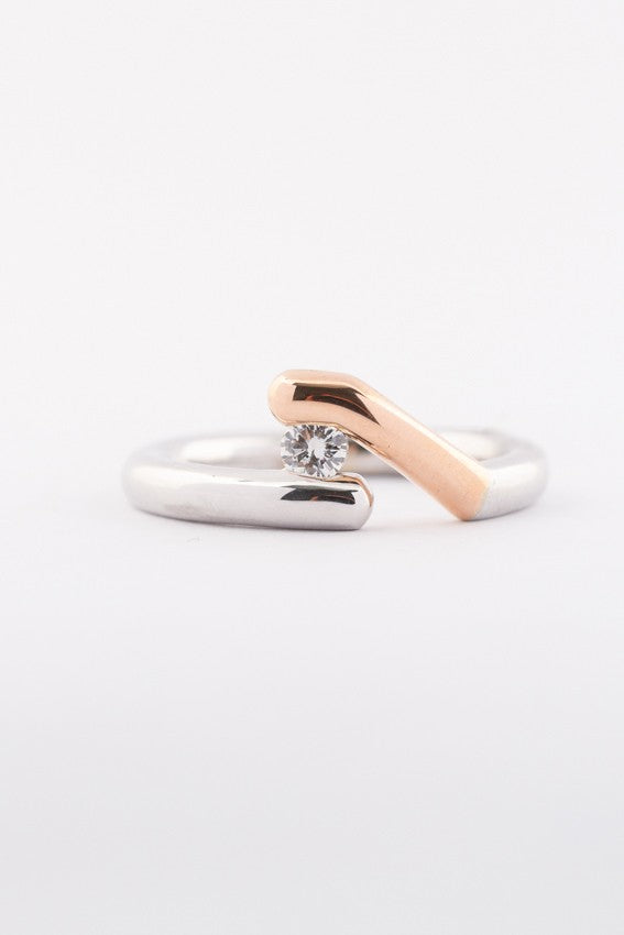 Solid white/rose gold ring with a 0.17 ct brilliant.