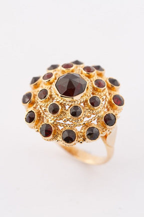 Gold double entourage ring with garnets