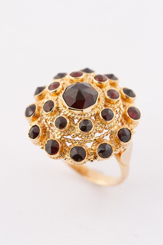 Gold double entourage ring with garnets