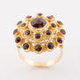 Gold double entourage ring with garnets