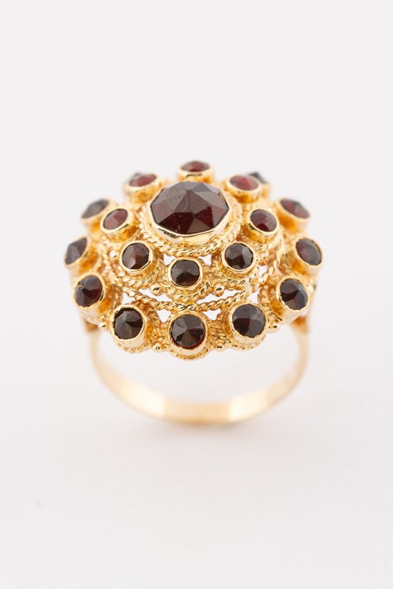 Gold double entourage ring with garnets