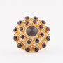 Gold double entourage ring with garnets