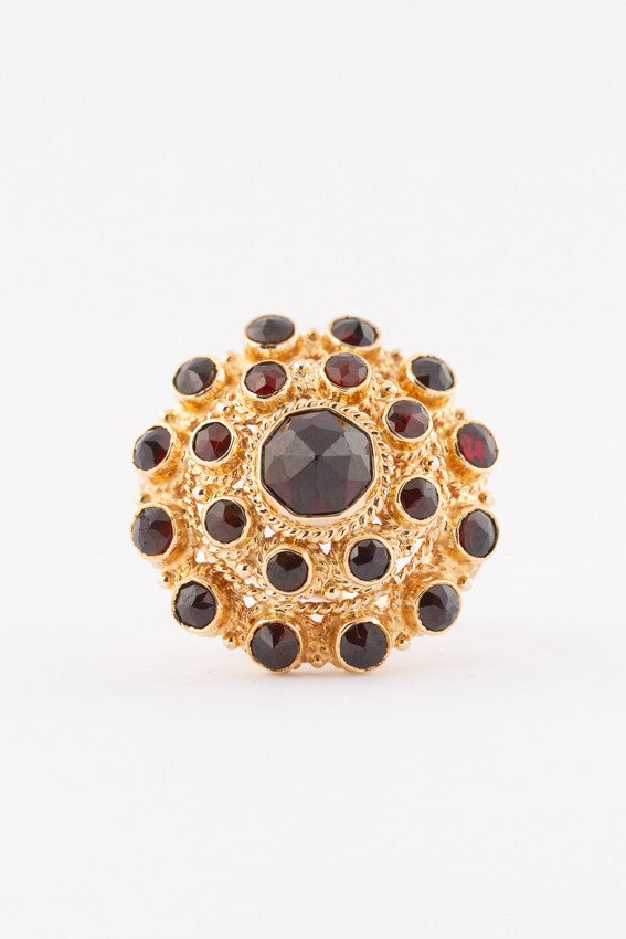 Gold double entourage ring with garnets