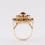 Gold double entourage ring with garnets