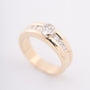Gold row ring with oval and round cut diamonds