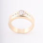 Gold row ring with oval and round cut diamonds