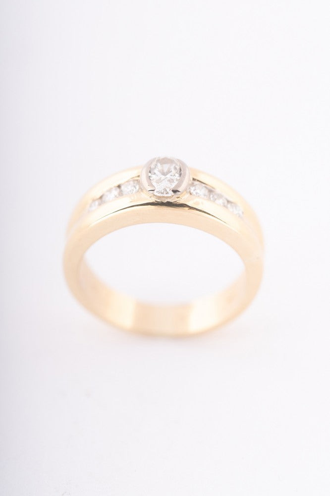 Gold row ring with oval and round cut diamonds