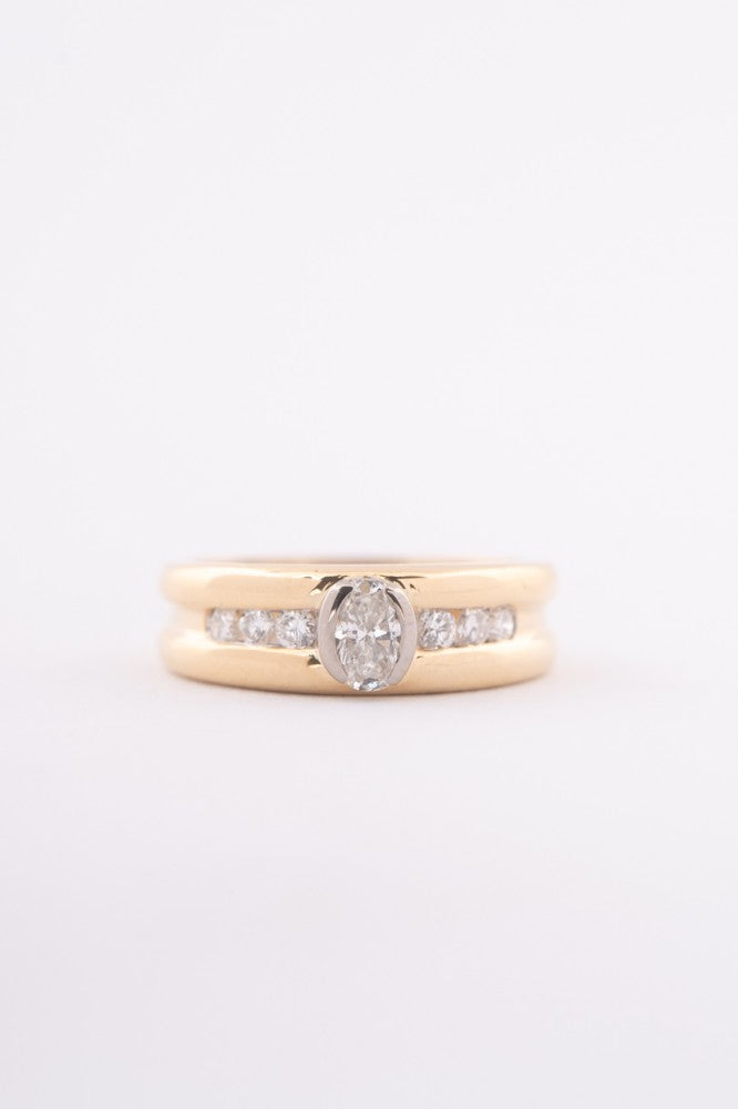 Gold row ring with oval and round cut diamonds