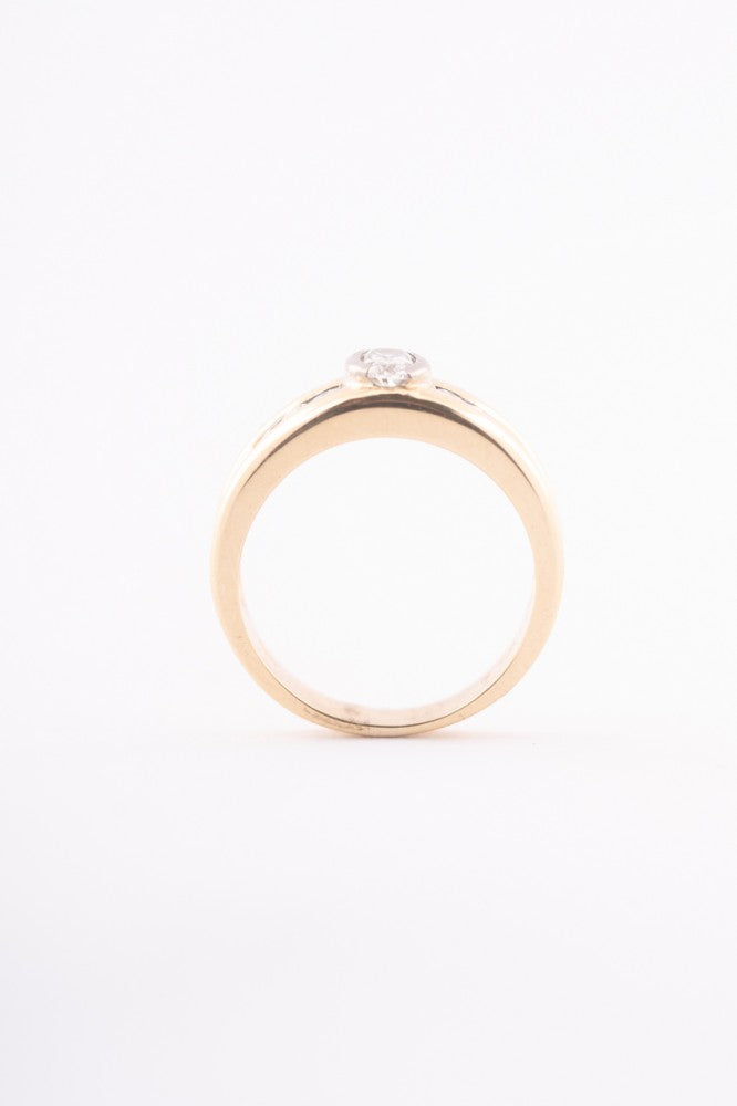Gold row ring with oval and round cut diamonds