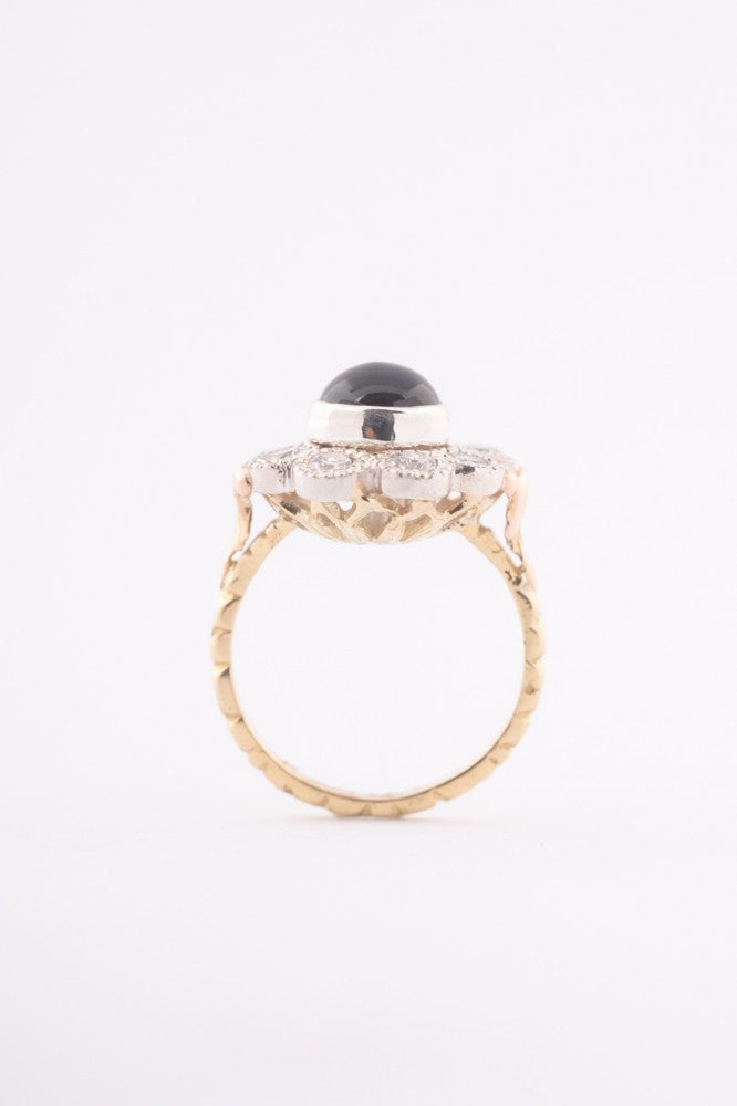 White/yellow gold entourage ring with topaz and diamonds