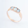 Gold row ring with 3 opals