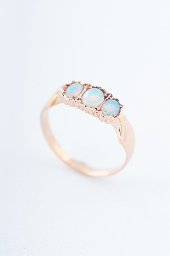 Gold row ring with 3 opals